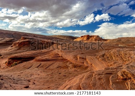 Waves of rock leading up to the blue sky and the clouds, The Chains, Page, Arizona, USA
