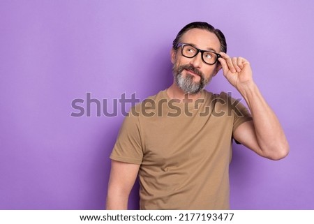 Photo of handsome positive man look empty space thinking about new project start-up isolated on violet color background