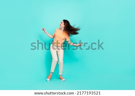 Full length photo of pretty cheerful girl enjoy clubbing dancing isolated on teal color background