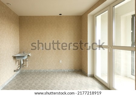 An empty kitchen with a budget clean renovation in a new apartment. High quality photo