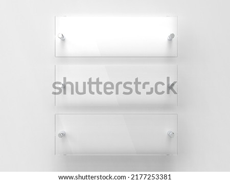 Three transparent glass nameplate plates on spacer metal holders. Clear printing boards for branding. Acrylic advertising signboards on white background . Size proportion 3 to 1. 3D illustration Royalty-Free Stock Photo #2177253381