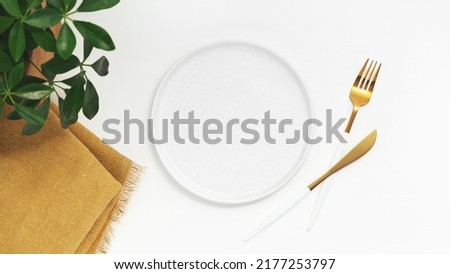Empty plate with fork and knife on white background. Top view. High quality photo