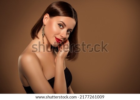 Studio portrait of bare shoulders stunning woman touching her cheekbone standing profile showing cosmetic night visage Royalty-Free Stock Photo #2177261009