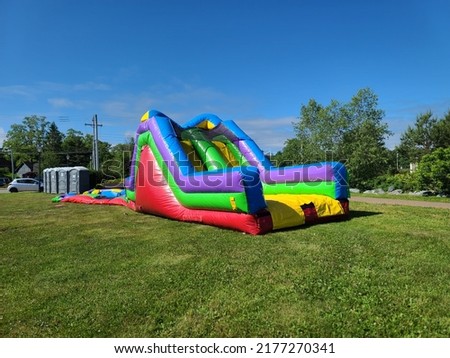 A bouncy castle slide that is being setup for children. Royalty-Free Stock Photo #2177270341