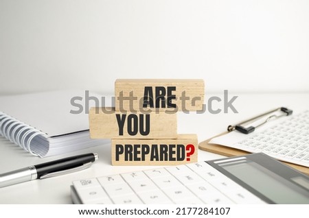 Are You Prepared Question, text on white paper on the light background with charts paper