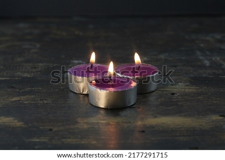 burning candle photo studio gold light of purple candle