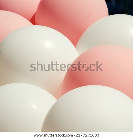 A bunch of Pink and white balloons side by side