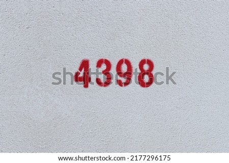 Red Number 4398 on the white wall. Spray paint.
