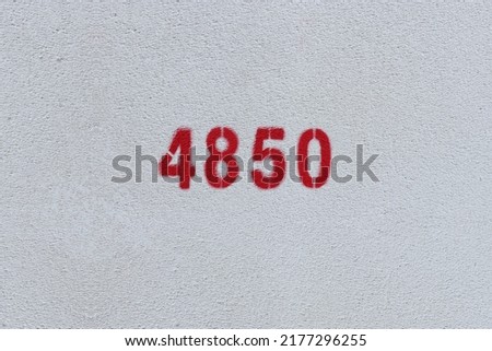 Red Number 4850 on the white wall. Spray paint.
