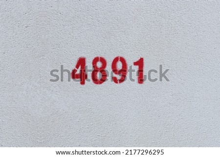 Red Number 4891 on the white wall. Spray paint.
