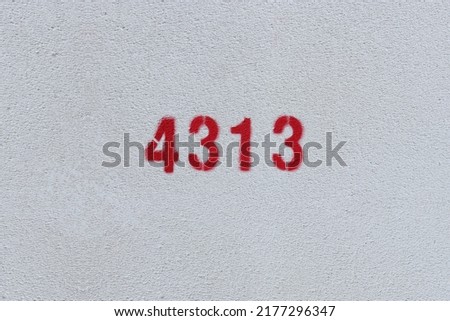 Red Number 4313 on the white wall. Spray paint.
