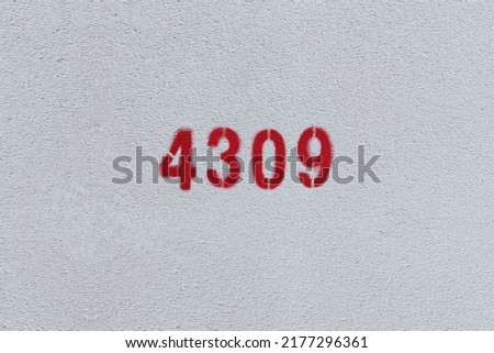 Red Number 4309 on the white wall. Spray paint.

