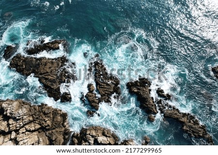 aerial view of the sea shore with rocks and sand