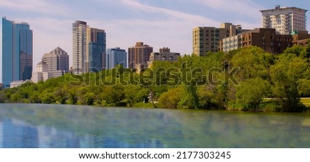 Milwaukee city skylines over a pond