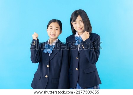 Couple of Asian schoolgirl fist pumping. Royalty-Free Stock Photo #2177309655