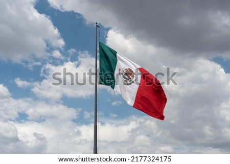 Mexican flag waving with blue sky and clouds in Mexico City - Mexico Flag Waving