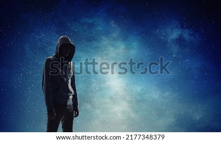 Silhouette of man in hoody Royalty-Free Stock Photo #2177348379