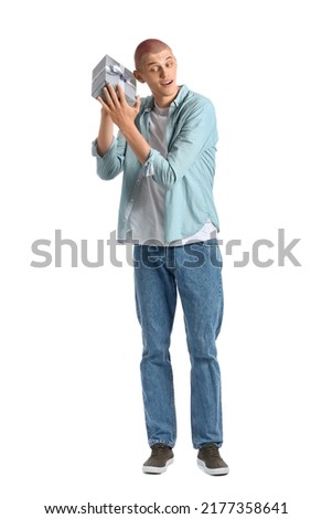 Young guy with gift box on white background