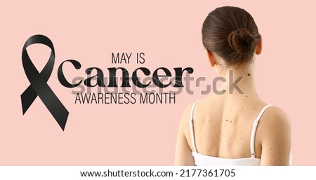 Young woman with moles, black ribbon and text MAY IS CANCER AWARENESS MONTH on pink background Royalty-Free Stock Photo #2177361705