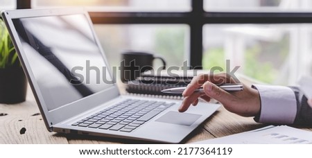 Typing on a tablet computer in a modern office. Make an account analysis report. real estate investment information financial and tax system concepts