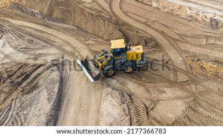 construction of a new toll road, solar glare, selective focusing, construction equipment at the road construction site close-up, road infrastructure construction concept