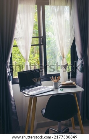 Vertical Image of Desk for student concept. Laptop Computer for study for exam, book, lamp place on School table for student work online at home. 