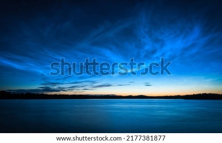 Beautiful midnight sky over the lake Royalty-Free Stock Photo #2177381877