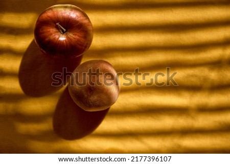 Creative food photography: apple, peach under trendy shadows. Top view. Vitamins, healthy food concept, copy space. Autumn mood board. High quality photo