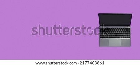 Top view of modern laptop isolated on colored background. Copy space.