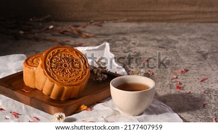 Mid autumn festival mooncake and and green tea on stone table Royalty-Free Stock Photo #2177407959