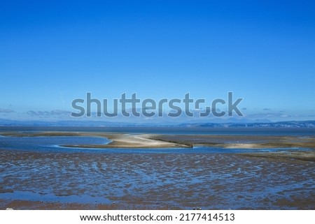 Low tide calm conditions at beach on the coast of east England UK
