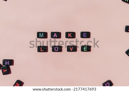 Make love not war. Black beads making phrase on beige background. Peace, hope, tolerance, friendship retro concept