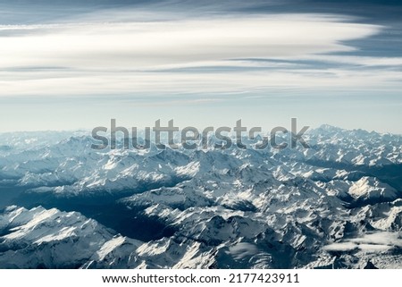 Winter view over the snowy Swiss Alps Mountains with the Matterhorn in the rear center, seen from an aircraft.