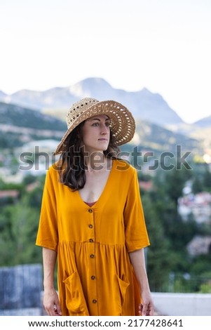 portrait of a beautiful young girl in a summer hat on the street. girl in summer clothes on vacation.