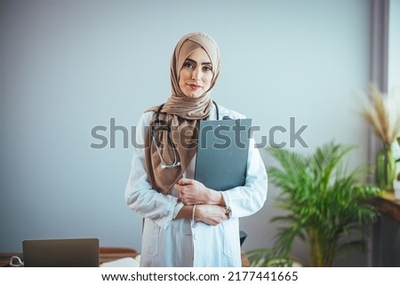 Muslim Arab person. The face of a female doctor on an isolated white background. The concept of Islamic health care in a technological research hospital. Nurse, nurse hijab nurse Royalty-Free Stock Photo #2177441665