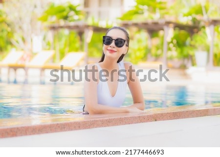 Portrait beautiful young asian woman relax smile leisure around outdoor swimming pool in hotel resort on vacation travel Royalty-Free Stock Photo #2177446693