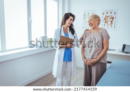Smiling female patient at consultation with woman doctor. Patient Having Consultation With Doctor In Office. Cropped shot of a medical practitioner reassuring a patient Royalty-Free Stock Photo #2177454339