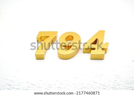    Number 794 is made of gold painted teak, 1 cm thick, laid on a white painted aerated brick floor, visualized in 3D.                                             