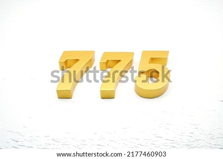    Number 775 is made of gold painted teak, 1 cm thick, laid on a white painted aerated brick floor, visualized in 3D.                              