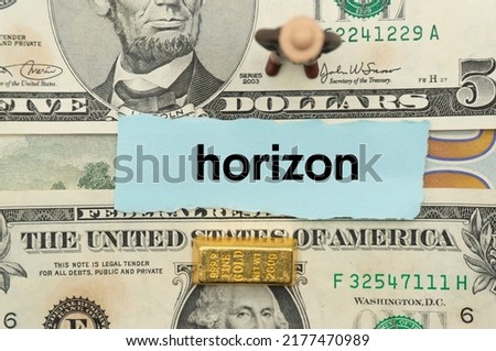 horizon.The word is written on a slip of paper,on colored background. professional terms of finance, business words, economic phrases. concept of economy.