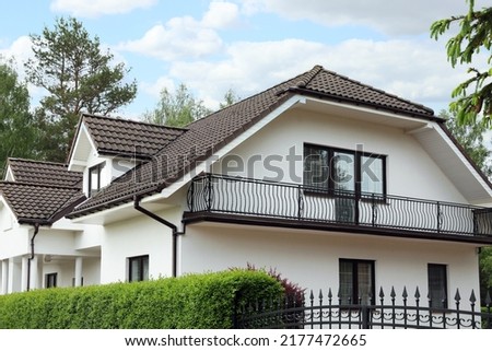 Modern building with brown roof outdoors on sunny day