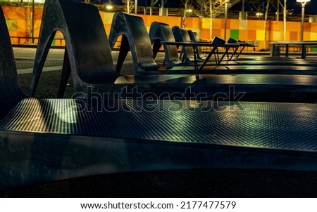 Street landscape. Recreation area. Original metal benches. Selective focus. Urban design