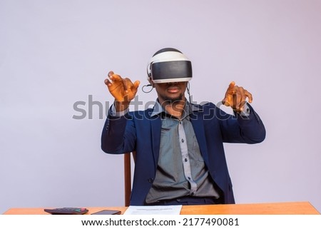 Young man using virtual reality headset. Isolated on gray background studio portrait. VR, future, gadgets, technology, education online, studying, video game concep
