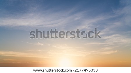 Sunset Sky clouds Background with Romantic Orange, Yellow Morning Sunrise, Golden Hour in the Summer Evening Sky Royalty-Free Stock Photo #2177495333