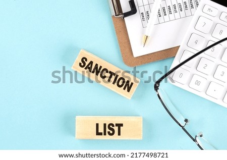 SANCTION LIST word concept on magnifier on the keyboard