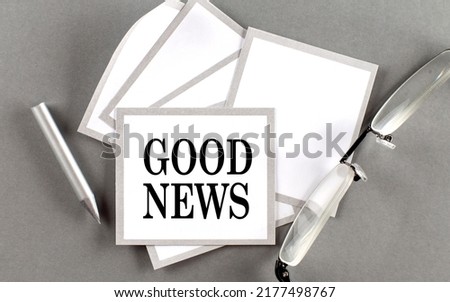 GOOD NEWS text written on sticky with pencil and glasses