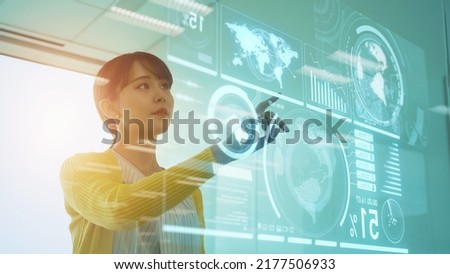 Asian woman watching hologram screen. Graphical User Interface. Head up display. Royalty-Free Stock Photo #2177506933