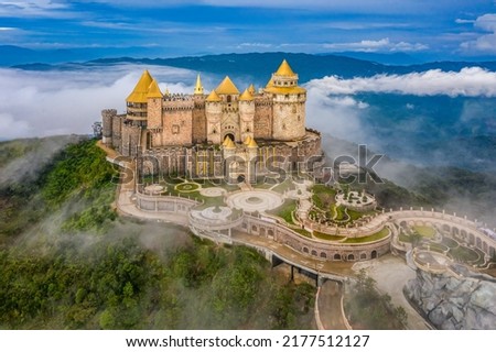 Aerial view of landscape is lunar castles covered with fog at the top of Bana Hills, the famous tourist destination of Da Nang, Vietnam. Near Golden bridge. Panorama Royalty-Free Stock Photo #2177512127