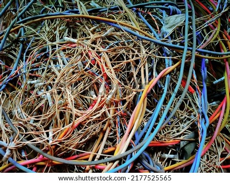 Messy pile of colorful cables network chaos of multicolor wires red, blue, yellow,black cable wires. Royalty-Free Stock Photo #2177525565