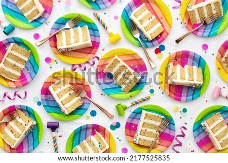 Colorful birthday party background of birthday cake slices on colorful rainbow plates at a birthday party Royalty-Free Stock Photo #2177525835